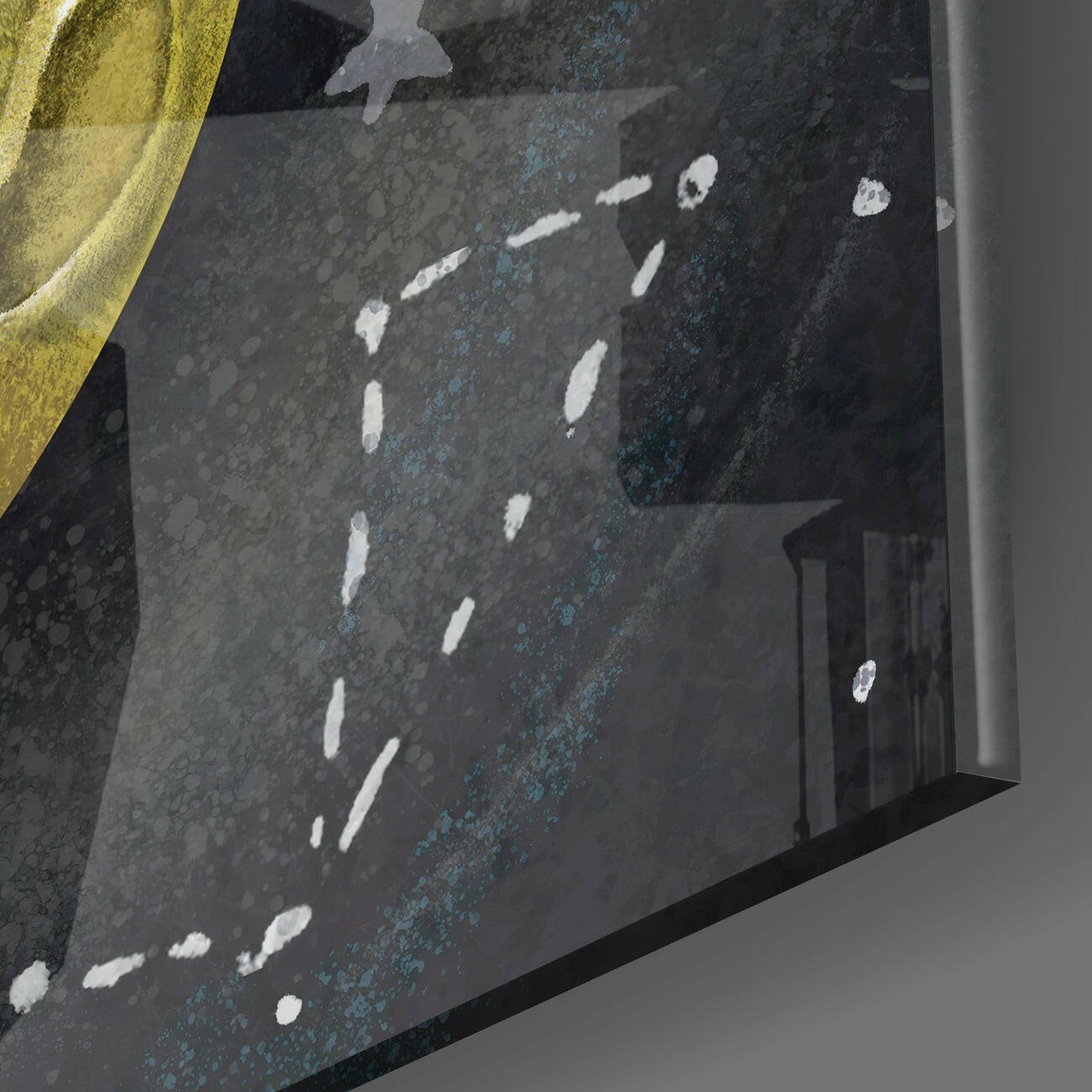 Dark textured glass wall art panel with white scattered marks and blue-green patina effects, installed at an angle against white wall trim.