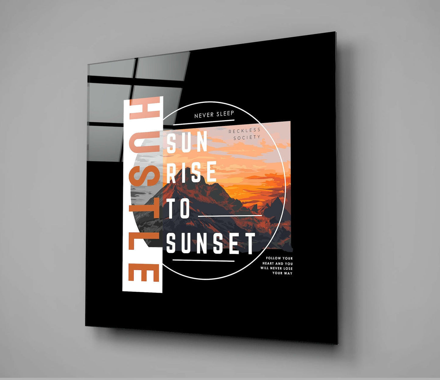 Black glass wall art featuring orange and white text "From Sunrise To Sunset" with circular mountain sunset photograph and inspirational quotes.