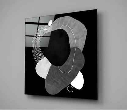 Black glass wall art displaying abstract geometric shapes in grayscale with white line details against dark background.