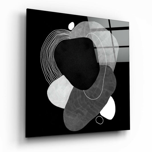 Black glass panel displaying abstract geometric composition with overlapping circles, lines, and shapes in white, gray, and black tones, angled perspective view.