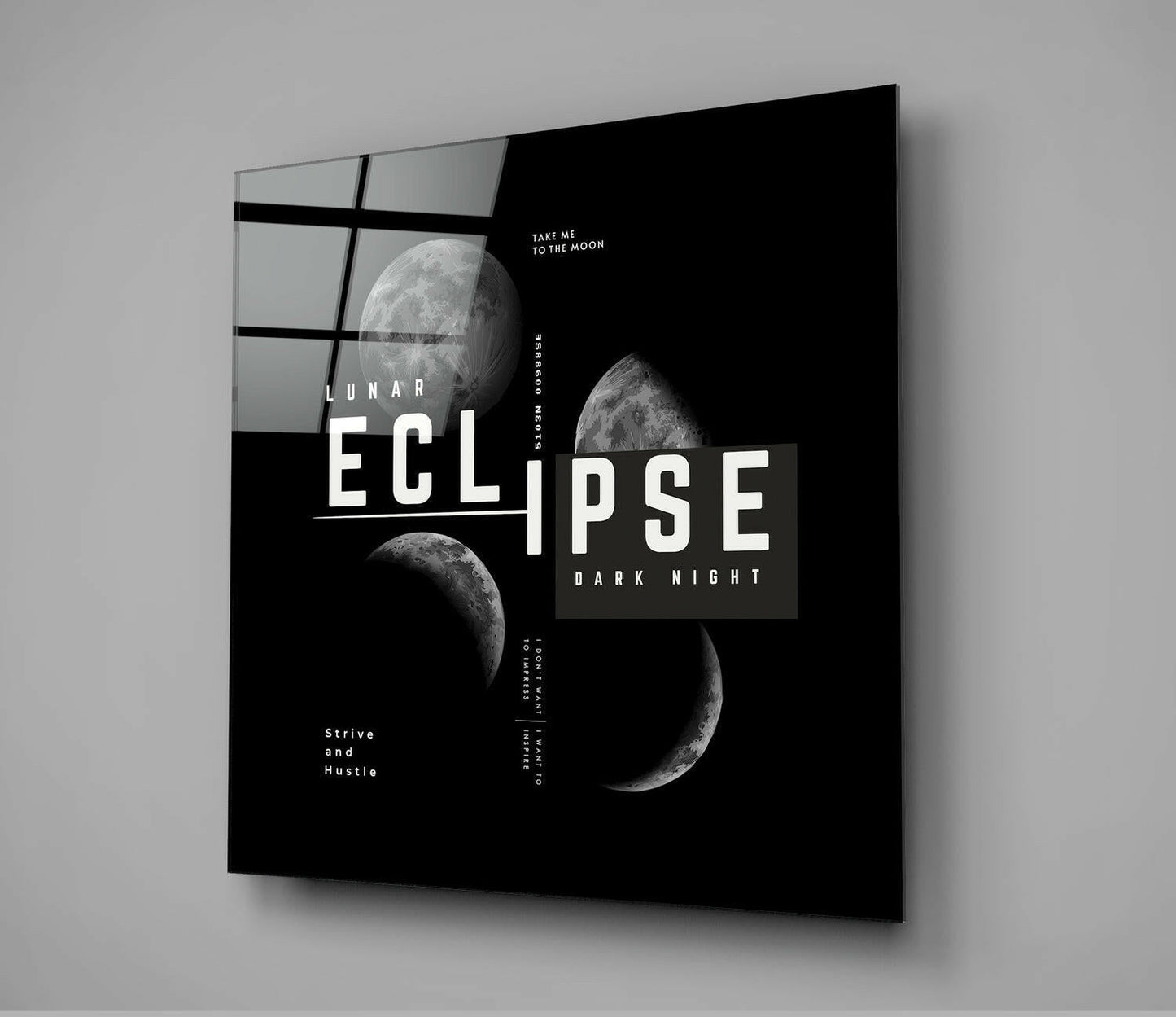 Angled perspective of black glass wall art featuring lunar eclipse phases, geometric grid pattern, and white typography on dark background.