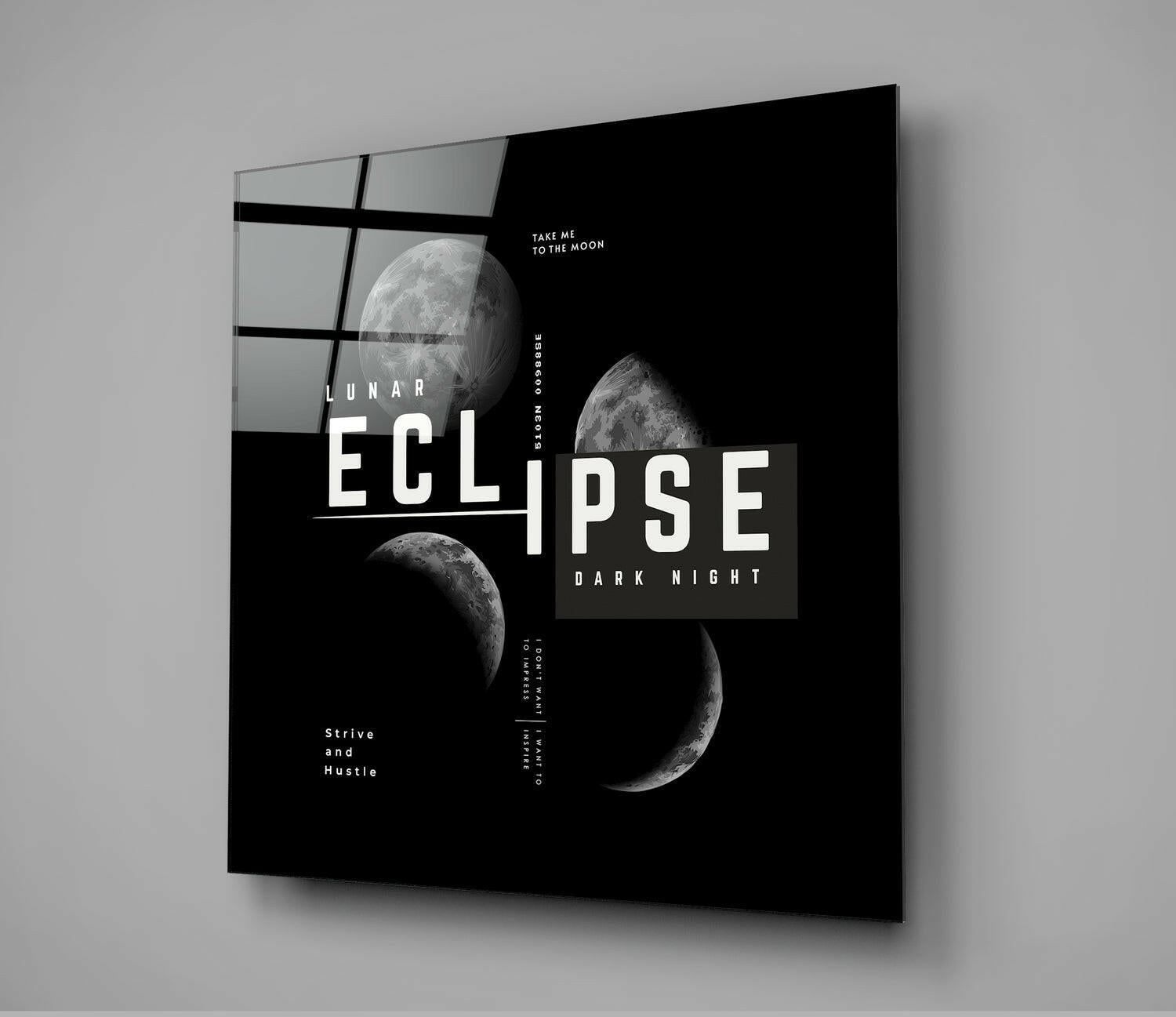 Angled perspective of black glass wall art featuring lunar eclipse phases, geometric grid pattern, and white typography on dark background.