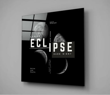 Angled perspective of black glass wall art featuring lunar eclipse phases, geometric grid pattern, and white typography on dark background.
