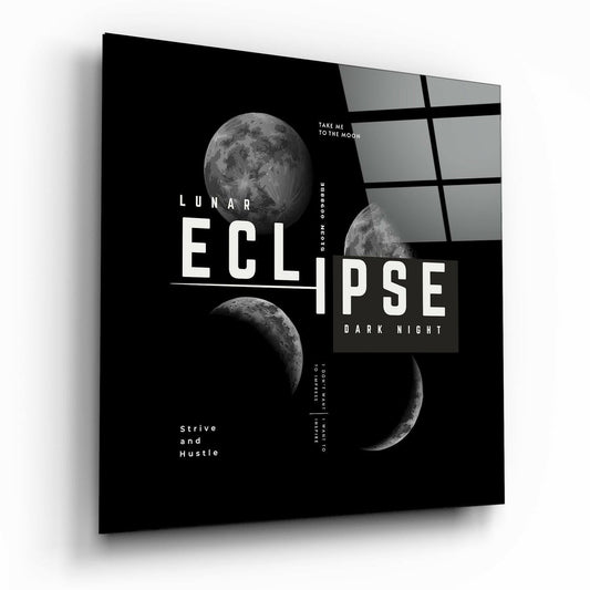 Angled view of black glass wall art featuring lunar eclipse phases, white typography, and gray grid pattern on right side.