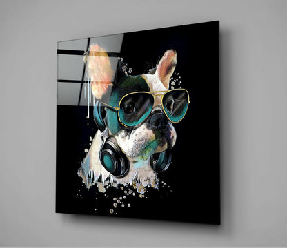Square glass wall art mounted on gray wall showing stylish French Bulldog wearing sunglasses and headphones against black background.