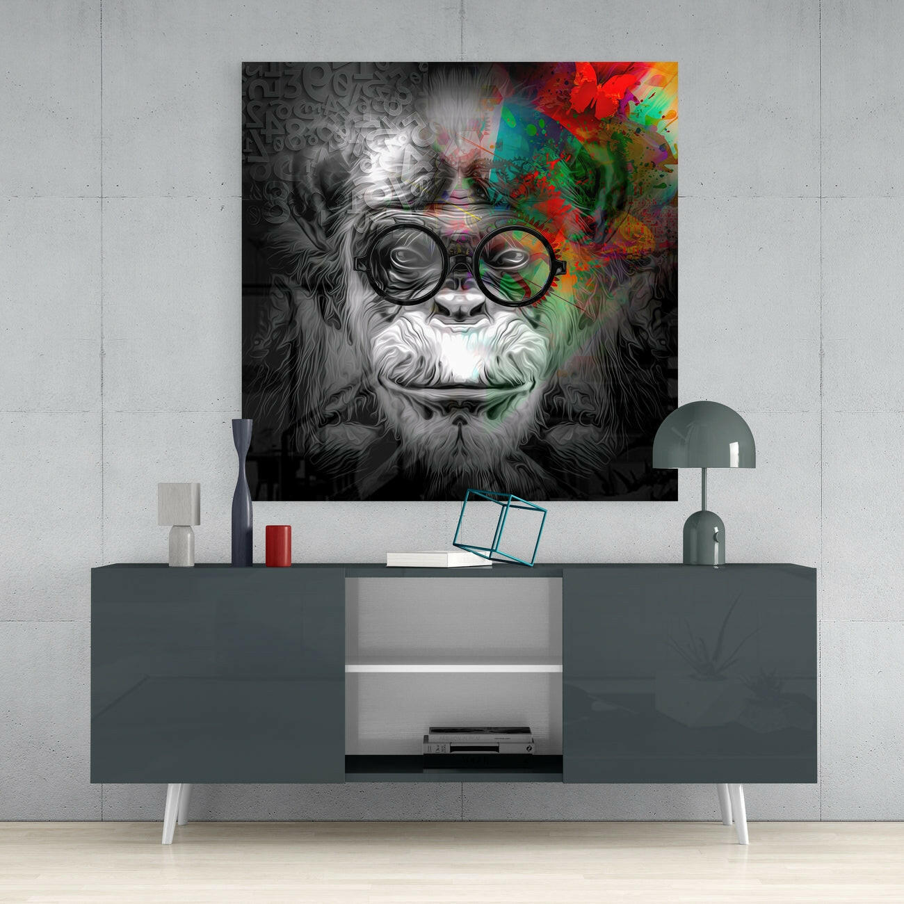 Black and white portrait of wise monkey wearing round glasses with colorful abstract overlay, displayed above dark console table in modern interior setting.
