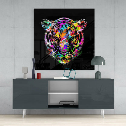 Vibrant multicolored tiger head artwork displayed on black glass mounted above a dark gray media console in a modern interior setting.