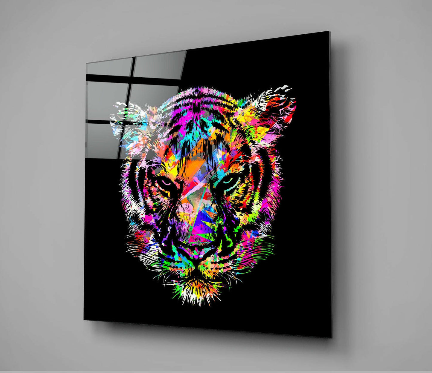 Vibrant neon tiger face on black glass panel mounted on gray wall, displayed at an angle.