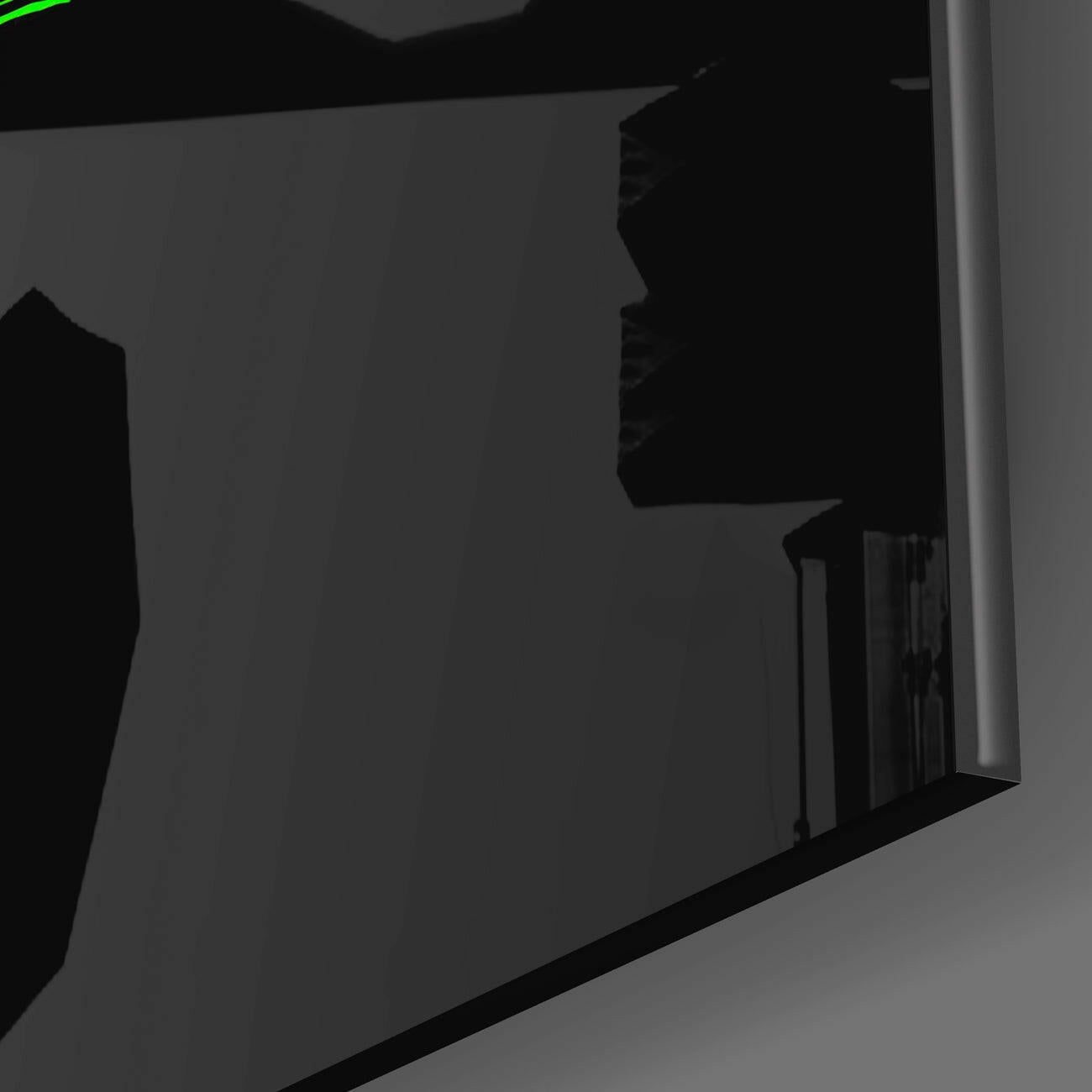 Close-up side angle of black glass wall art panel showing edge detail and reflective surface against gray background.