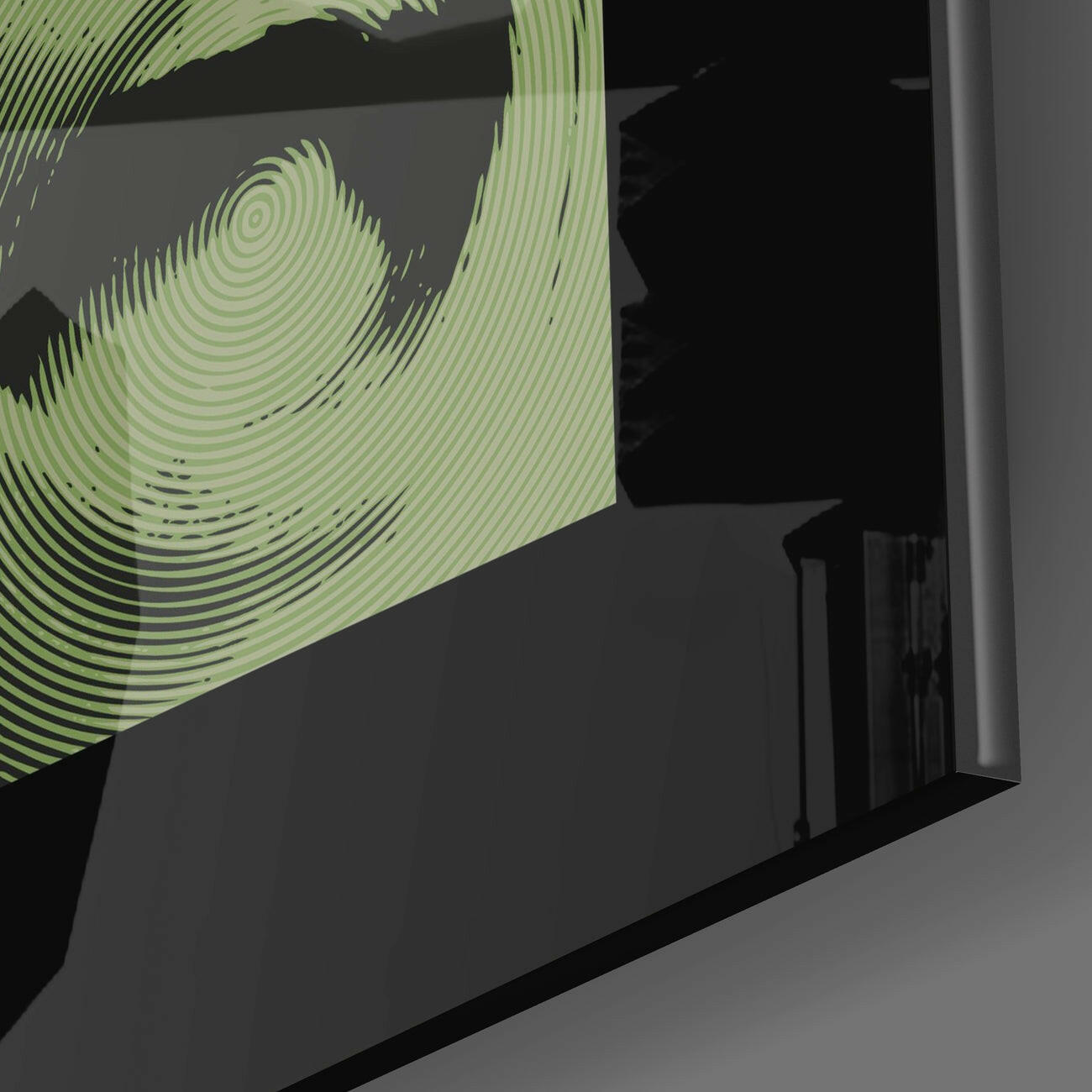 Close-up angled view of green concentric circular line patterns on translucent glass panel against dark background.
