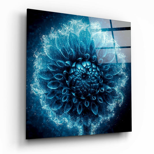 Angled perspective of frosted blue dahlia glass wall art with glowing crystalline petals on dark teal background and horizontal glass divisions.