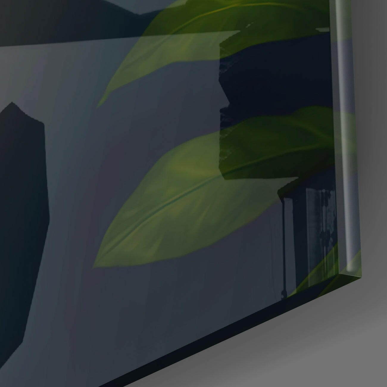 Close-up angled view of green leaf design on translucent glass panel with dark background.