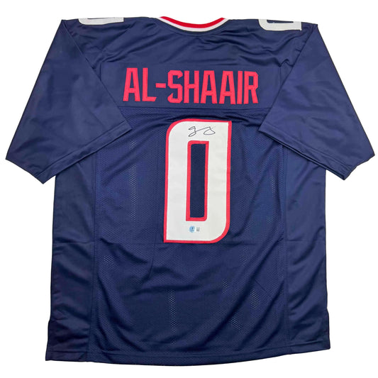 Navy blue football jersey displaying "AL-SHAAIR" across back shoulders and number "0" with signature on white numeral, flat lay back view.