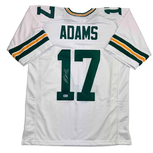 White Green Bay Packers #17 Adams jersey displayed flat, showing front with green and gold striped sleeves and autographed number.