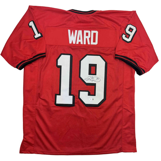 Red Georgia college football jersey number 19 with "WARD" nameplate, displayed flat, showing front and back views with autograph.