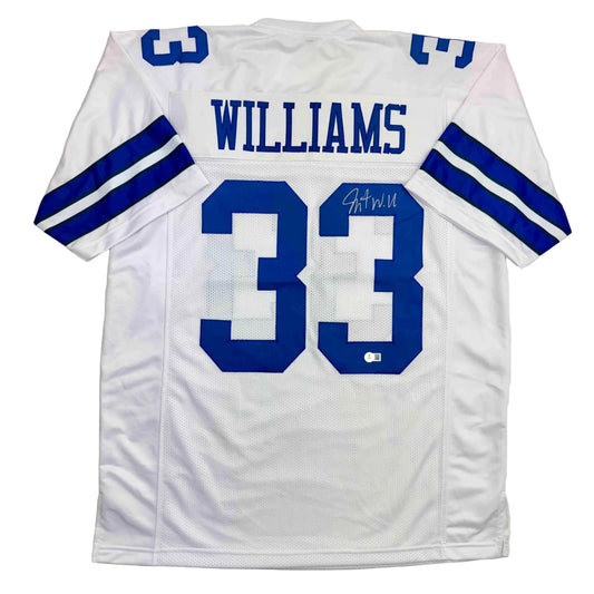 Back view of white Dallas football jersey number 33 with "WILLIAMS" nameplate and autographed signature in blue.
