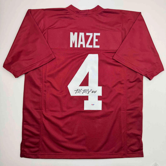 Back view of signed maroon Alabama football jersey with "MAZE" and number "4" in white, displayed flat against white background.