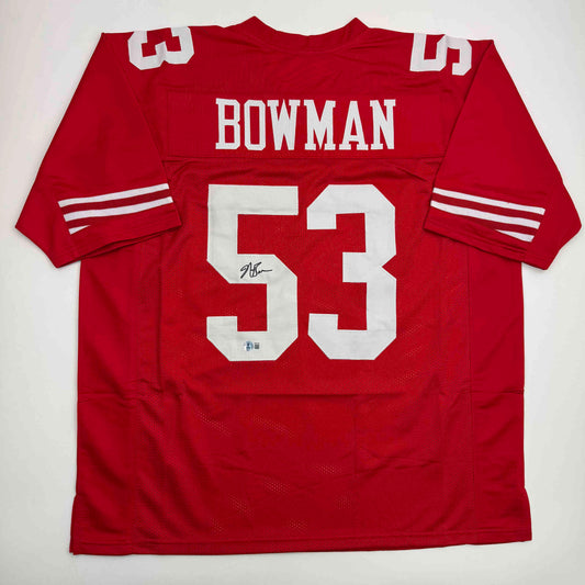 Red San Francisco football jersey number 53 with "BOWMAN" nameplate, displayed flat against white background, showing front view with white striping on sleeves and autographed number.