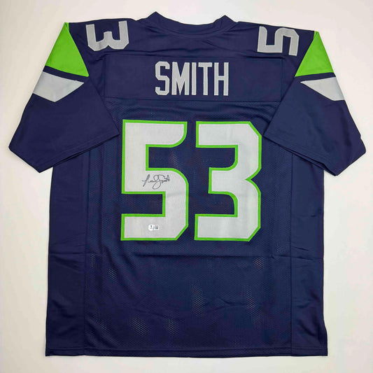 Back view of navy blue Seattle Seahawks jersey number 53 with "SMITH" nameplate and autographed signature on white and green numbered patch.