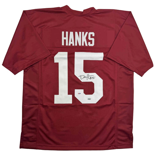 Back view of maroon Alabama football jersey number 15 with "HANKS" nameplate and signature, displayed flat against white background.