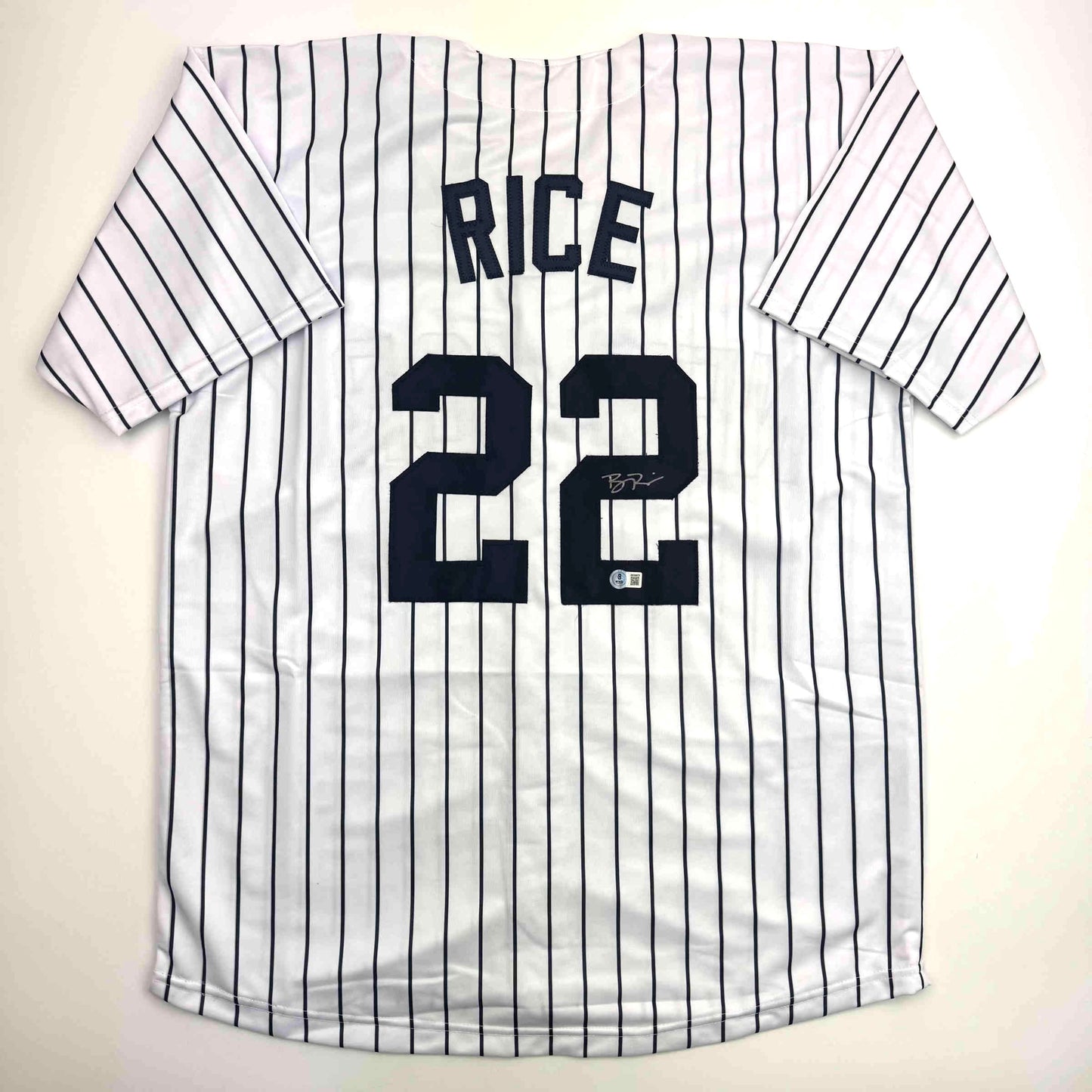 White pinstriped baseball jersey with "RICE" and number "22" in dark blue lettering, displayed flat against light background.