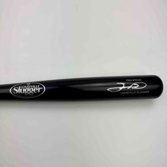 Black Louisville Slugger Pro Stock baseball bat with printed logo and signature displayed against white background in horizontal angle view.