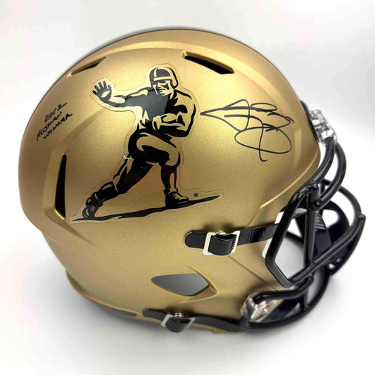 Gold full-size football helmet with black facemask and player silhouette logo, displayed at three-quarter angle showing autographed signature on side.