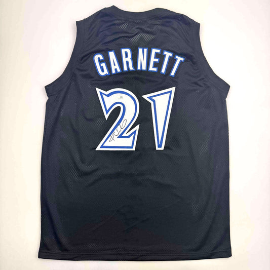 Back view of navy mesh basketball jersey with "GARNETT" and number "27" in blue and white lettering, signed in black marker.