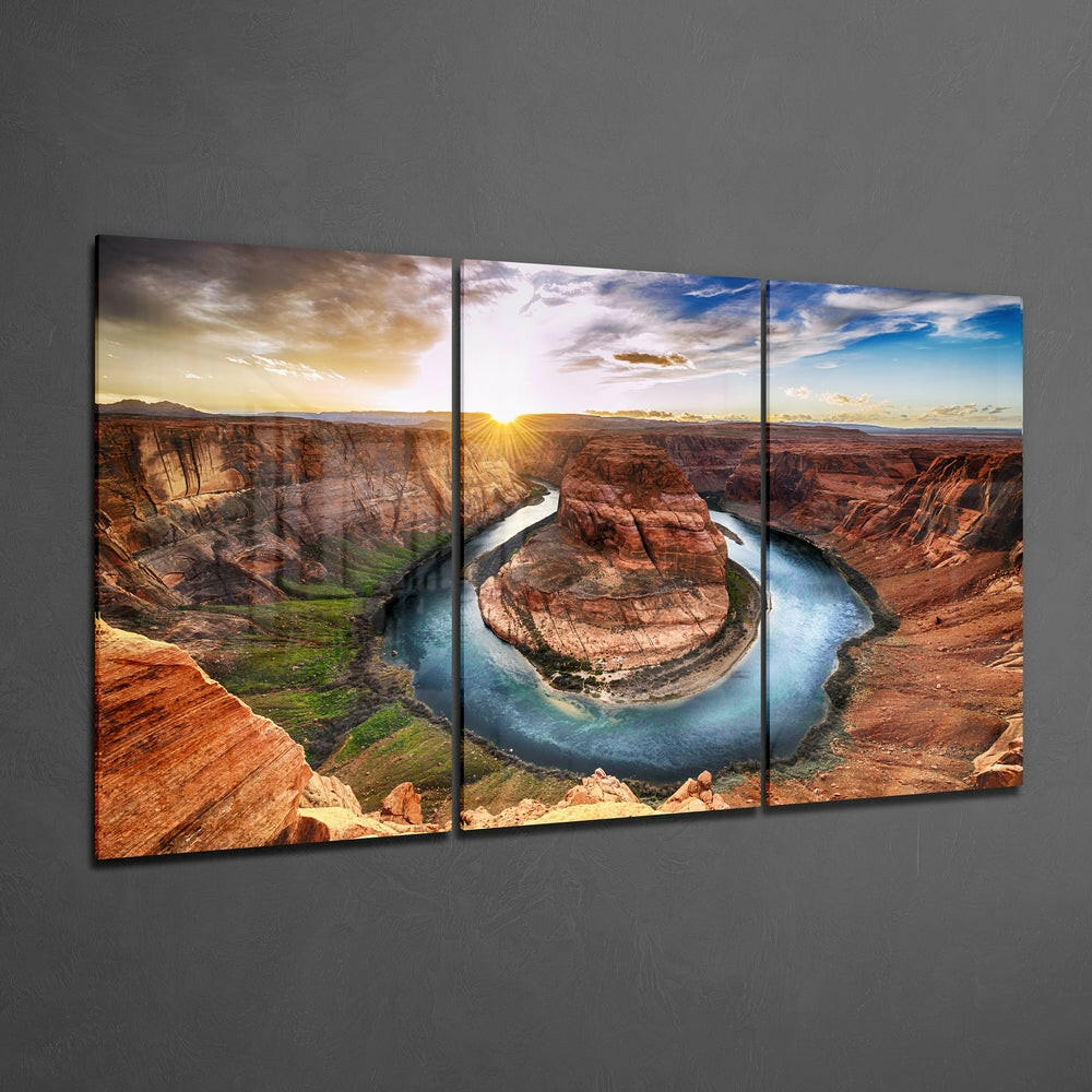 Three-panel glass wall art displaying Horseshoe Bend canyon landscape with river, red rock formations, and sunset sky.