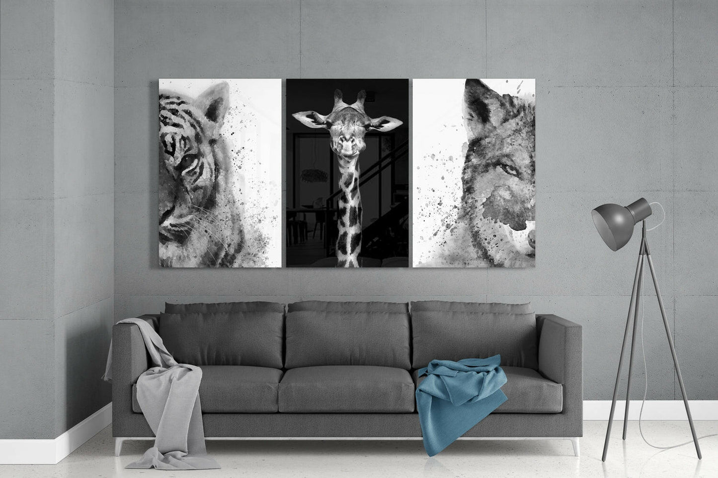 Three black and white animal portraits—tiger, giraffe, and wolf—displayed as glass panels above a gray sofa in a modern living room.