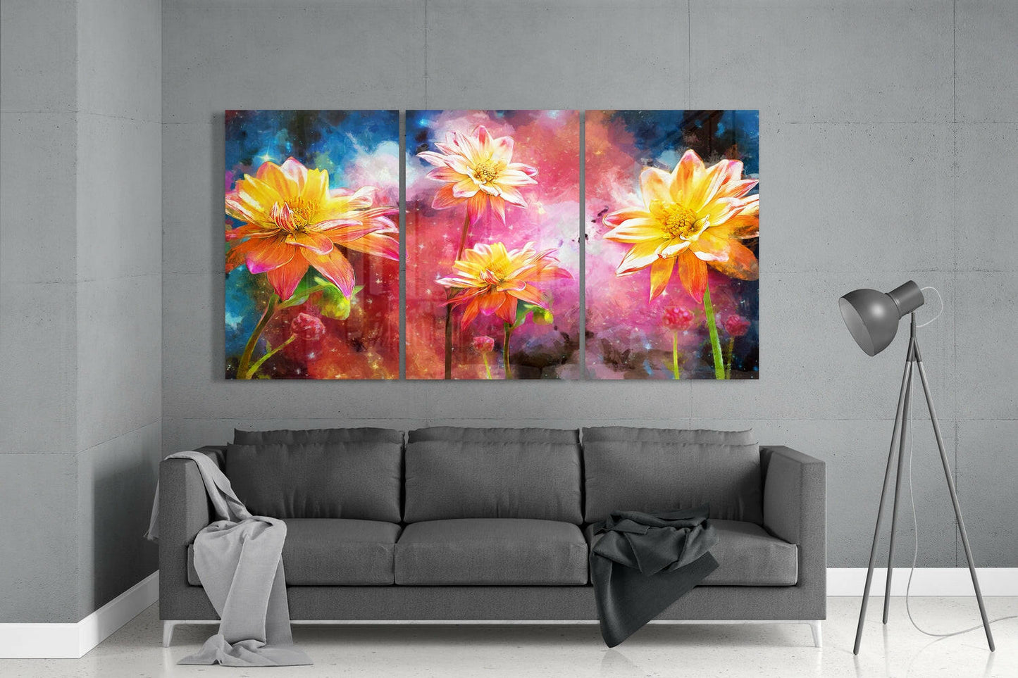 Three-panel vibrant glass wall art displaying yellow and orange flowers with pink and blue watercolor backgrounds, hung above gray sofa in modern living room.