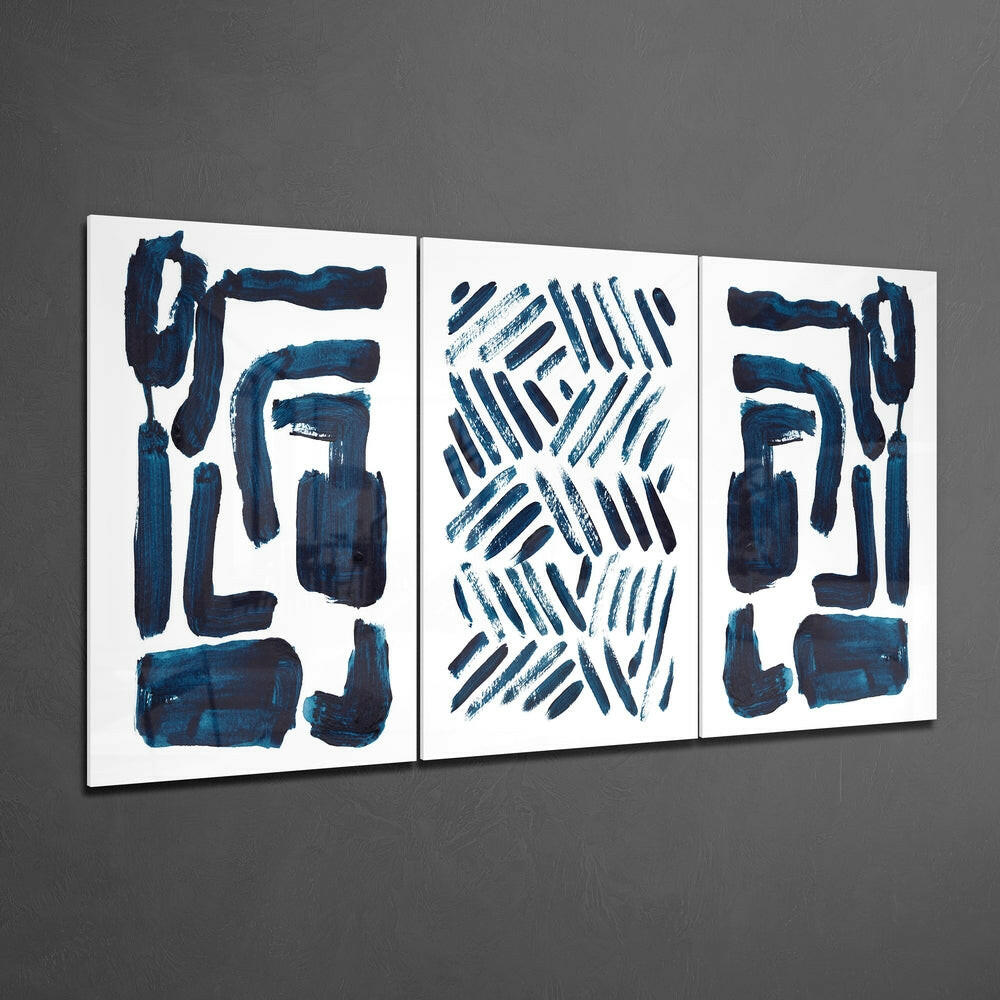 Three framed glass panels with abstract dark blue brushstrokes and geometric patterns on white background, mounted on gray wall.