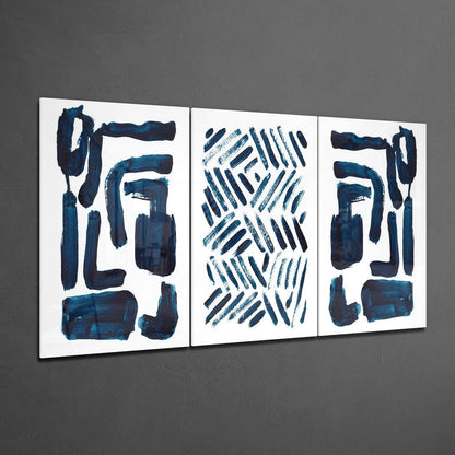 Three framed glass panels with abstract dark blue brushstrokes and geometric patterns on white background, mounted on gray wall.