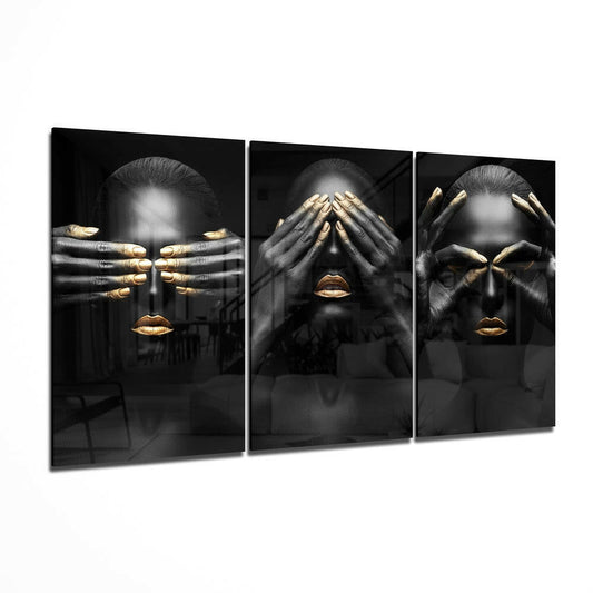 Three-panel black glass wall art featuring women with gold-accented nails and lips in monochromatic portrait style.