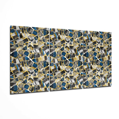Three-panel glass wall art displaying a geometric mosaic pattern of blue, gold, black, and white angular shapes arranged in a seamless repeating design.