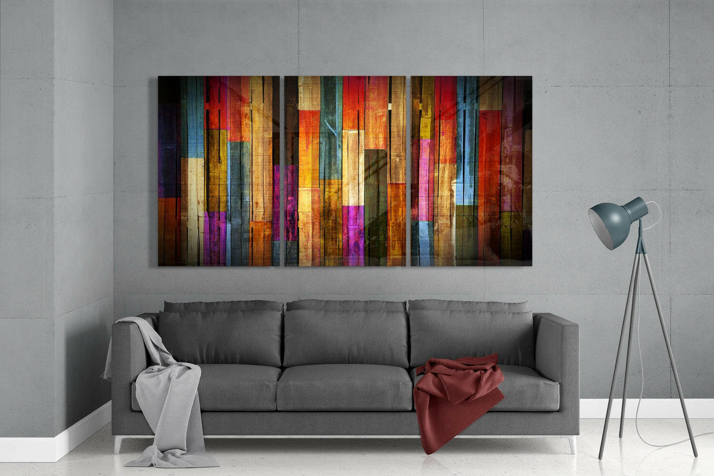 Colorful vertical striped glass wall art hanging above gray sofa in modern living room interior.