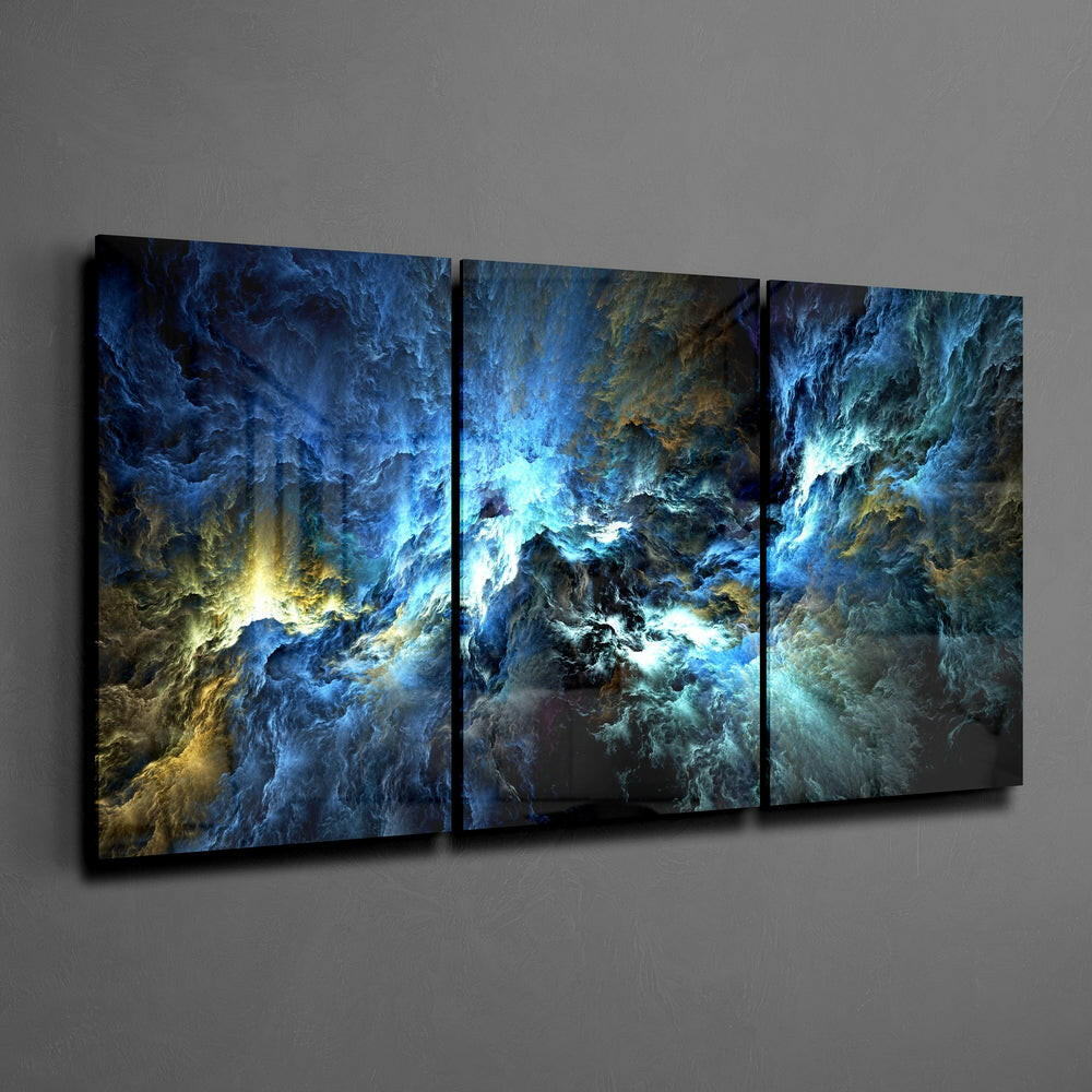 Three-panel glass wall art displaying swirling blue, gold, and turquoise abstract patterns mounted on gray wall.