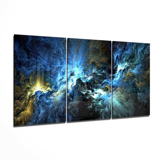 Three-panel glass wall art displaying swirling blue and gold abstract formations with bright cyan light at center, angled perspective view.