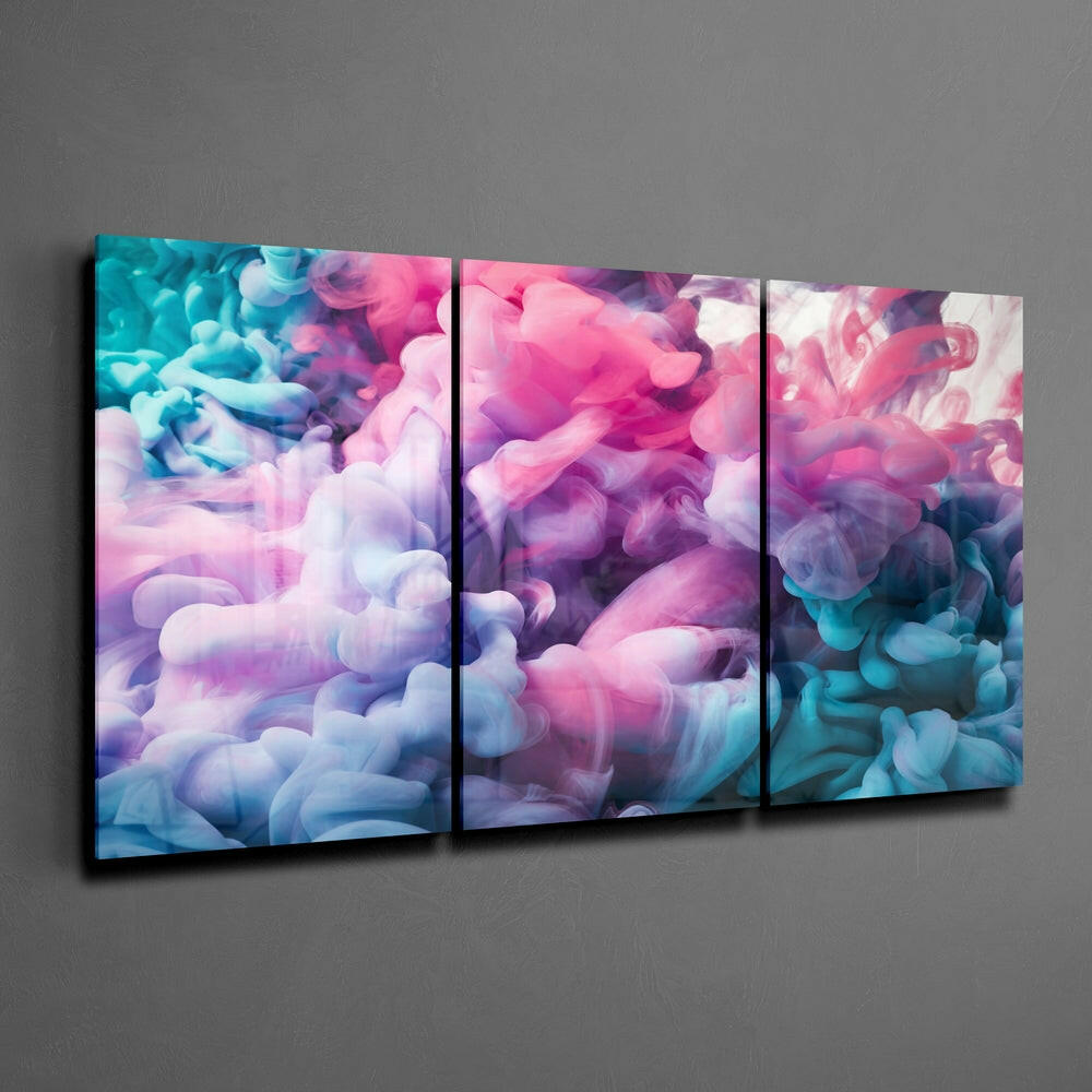 Three-panel glass wall art displaying swirling pastel smoke in pink, purple, blue, and white clouds mounted on gray wall.