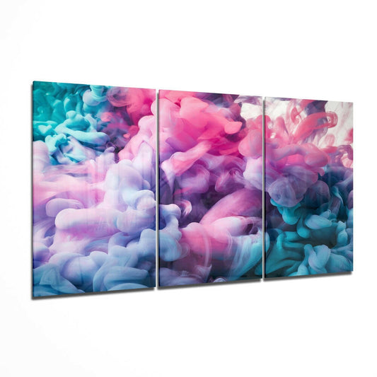 Three-panel glass wall art displaying swirling pastel pink, purple, blue, and white smoke effects in an angled perspective view.