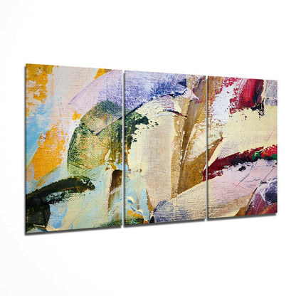 Three-panel abstract glass wall art featuring colorful brushstrokes in yellow, blue, green, red, and cream tones with textured canvas-like surface.