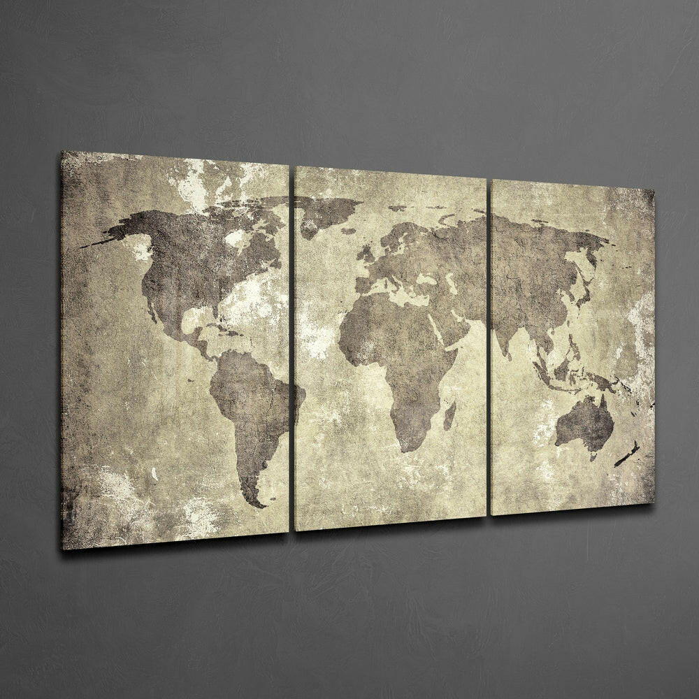 Three-panel antique world map canvas with distressed beige and brown tones hanging on gray wall at an angle.