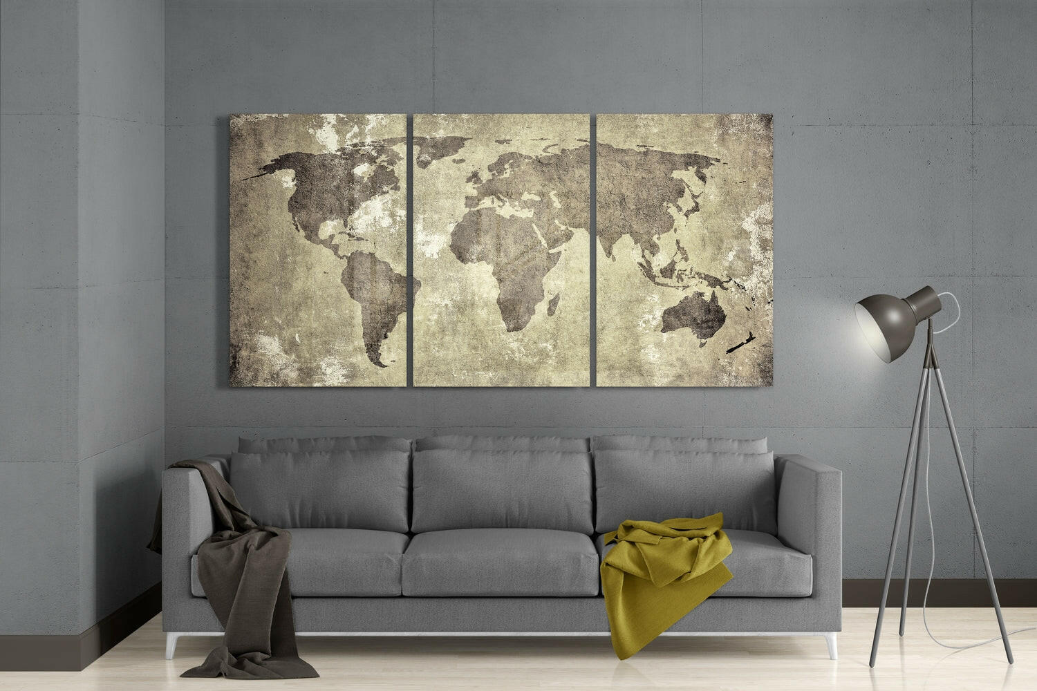 Three-panel antique world map wall art in sepia tones displayed above gray sofa in modern living room setting.