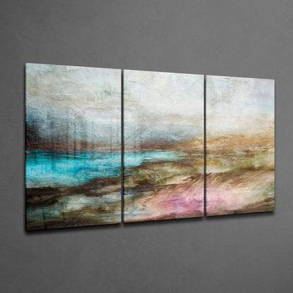 Three-panel abstract glass wall art displaying layered horizontal bands of turquoise, brown, beige, and pink tones hung on gray wall.