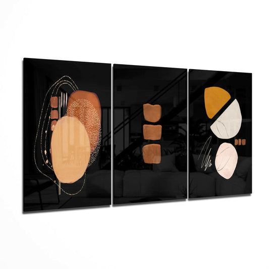 Three-panel glass wall art displaying abstract geometric shapes in terracotta, gold, cream, and black on dark backgrounds.
