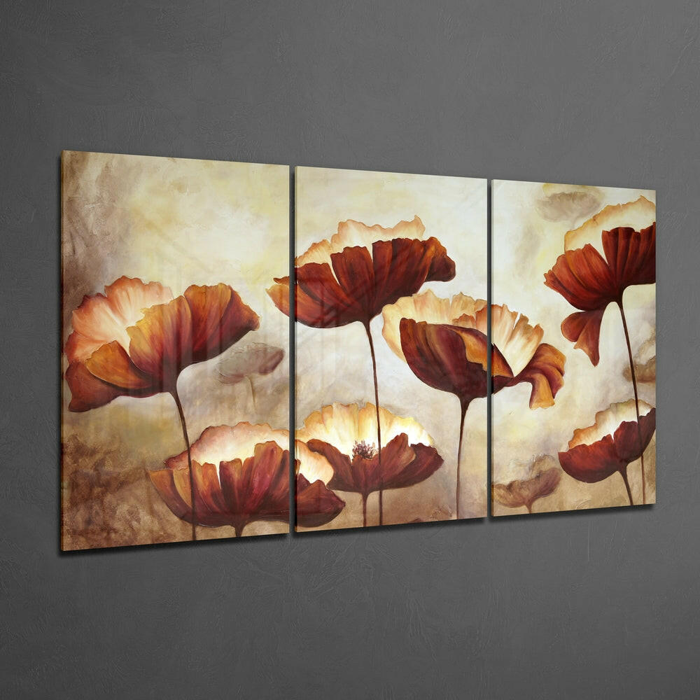 Three-panel glass wall art displaying red and orange poppies with cream petals against a textured beige background, mounted on gray wall.