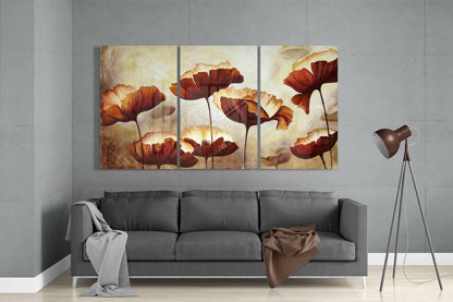 Three-panel glass wall art depicting red and orange poppies with cream background hanging above gray sofa in modern living room.