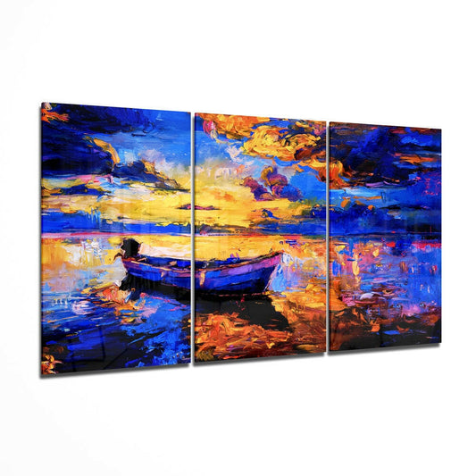 Three-panel glass wall art displaying a vibrant sunset seascape with boats in bold blues, yellows, and oranges, shown at an angled perspective.
