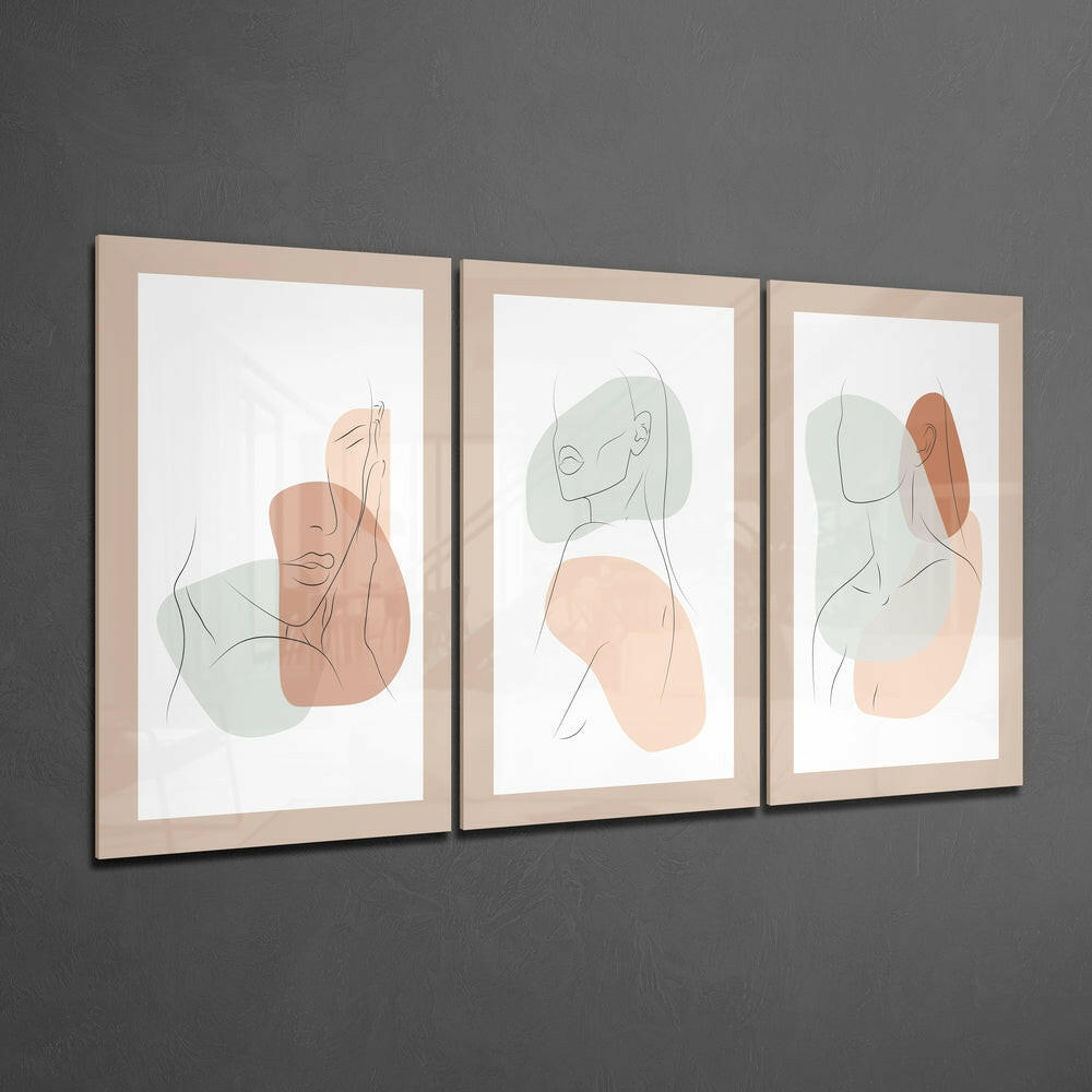 Three framed abstract line drawings with minimalist faces and watercolor shapes in beige, terracotta, and sage green tones mounted on gray wall.