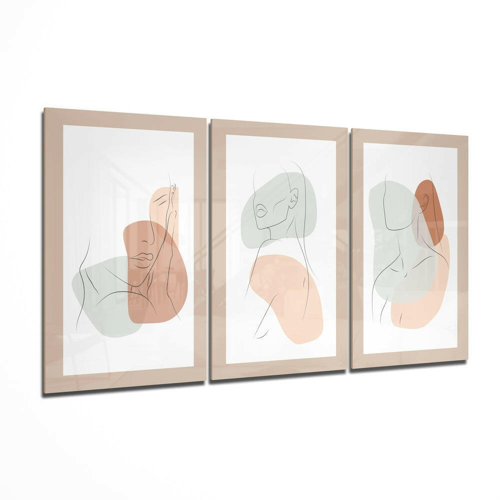 Three framed abstract line drawings with minimalist faces and soft peach and sage green watercolor shapes on white backgrounds, displayed in light wood frames.